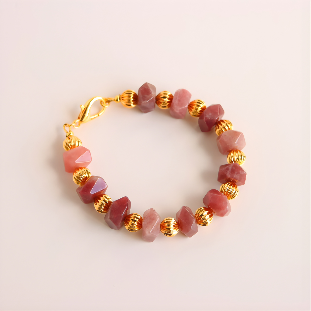 Beaded bracelet with pink Botswana agate stones and gold accents on a light background