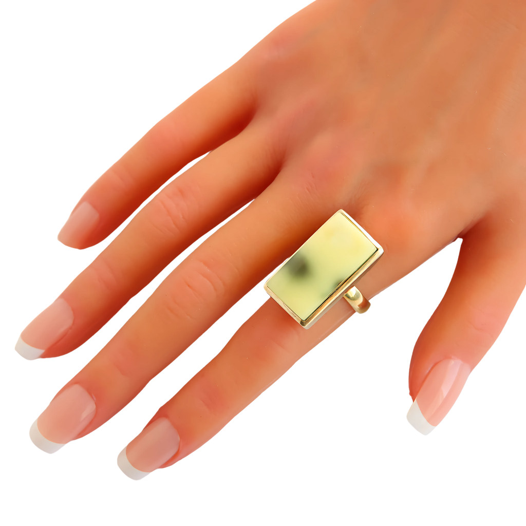 Rare butterscotch lime Baltic amber ring set in gold plated sterling silver on a hand.