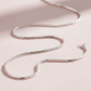 sterling silver box chain necklace on light pink background