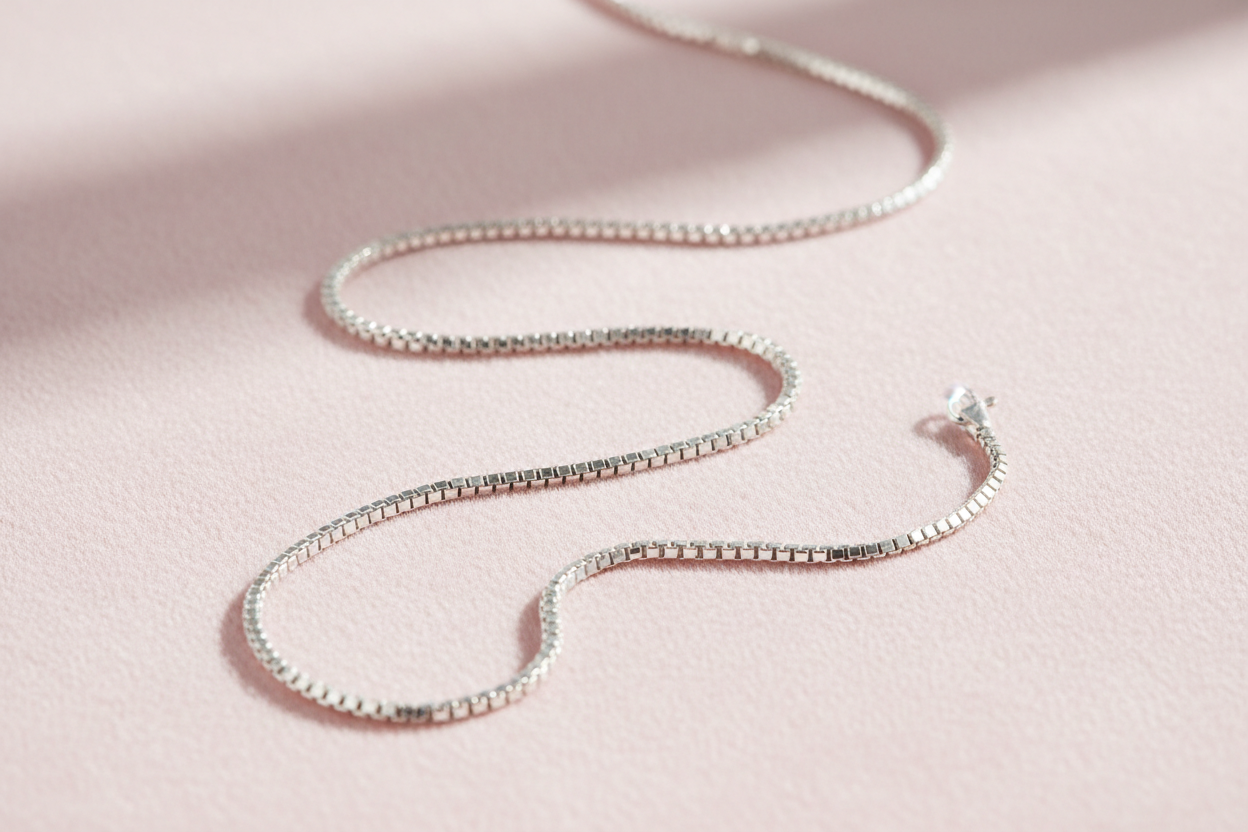 sterling silver box chain necklace on light pink background