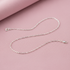 plain sterling silver cable chain on pinkish background
