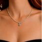 Model wearing turquoise necklace close up with red hair