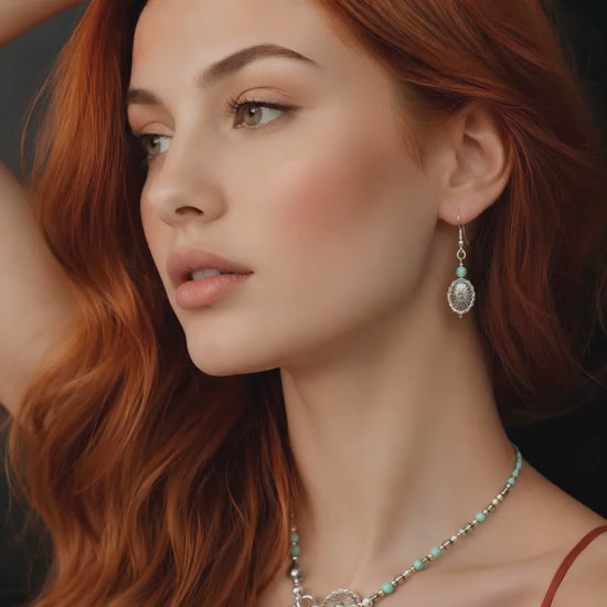 red hair model wearing western earrings on dark background