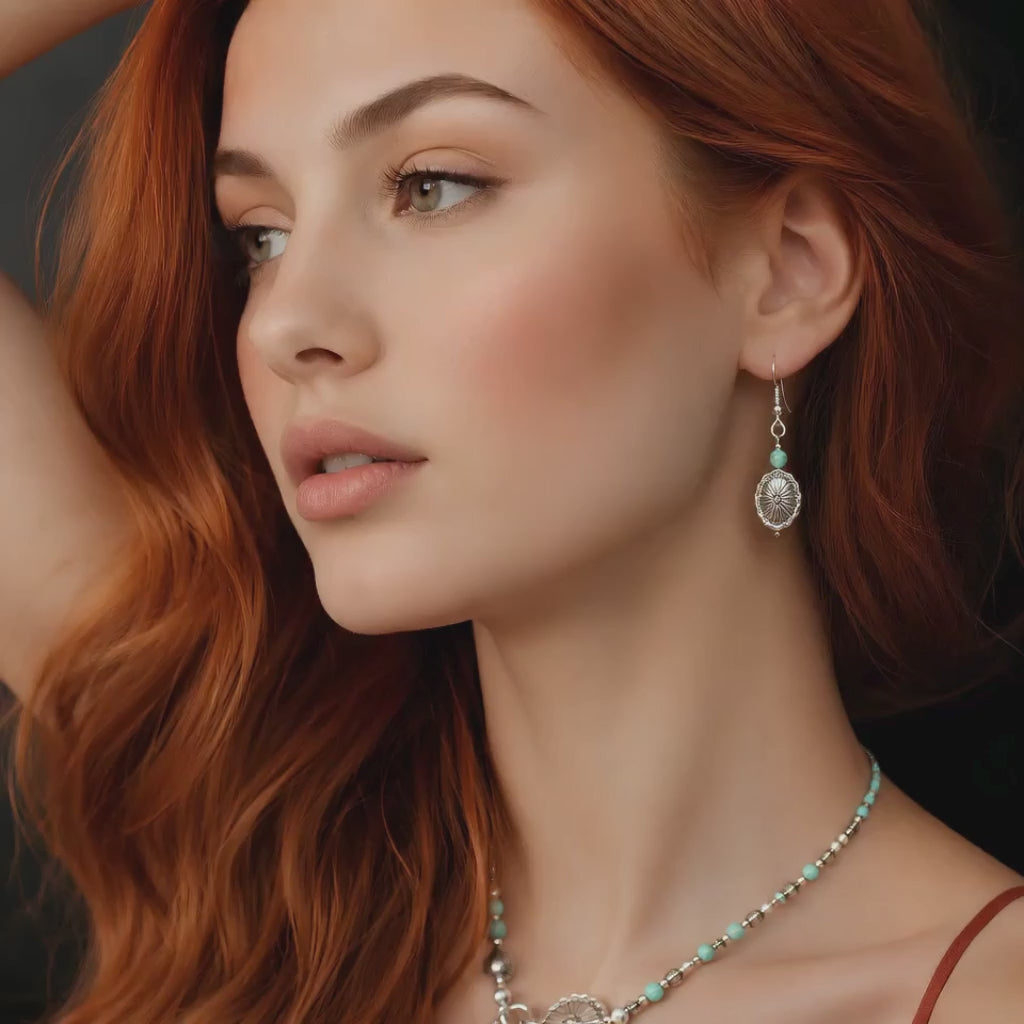 red hair model wearing western earrings on dark background