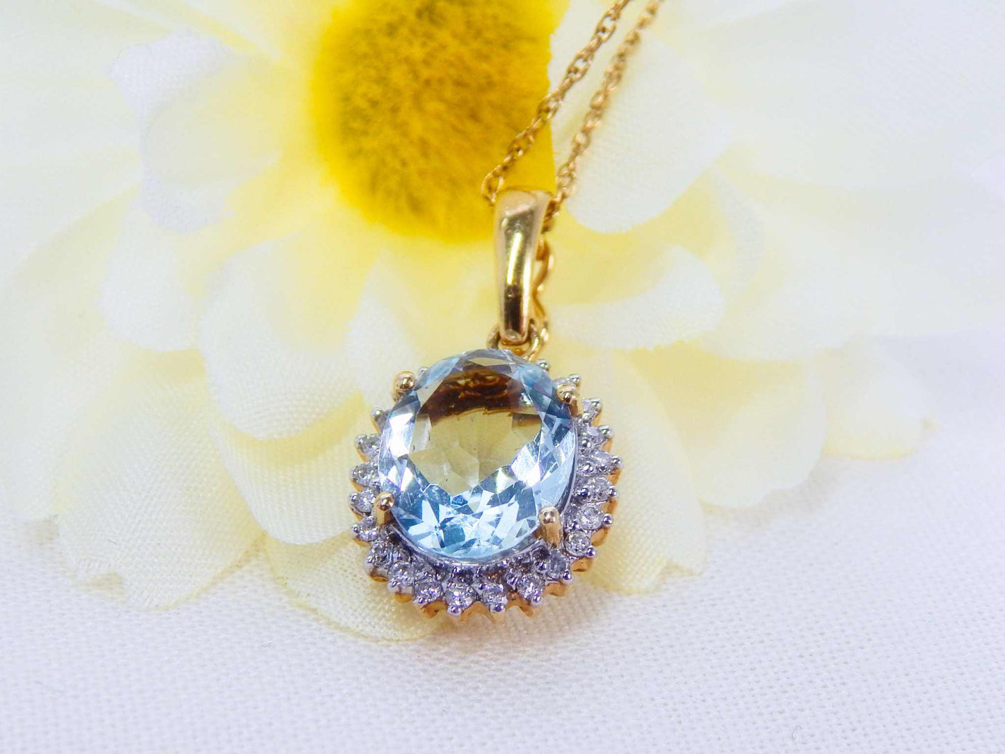 14K yellow gold aquamarine pendant with diamond halo pendant on a 22-inch chain.