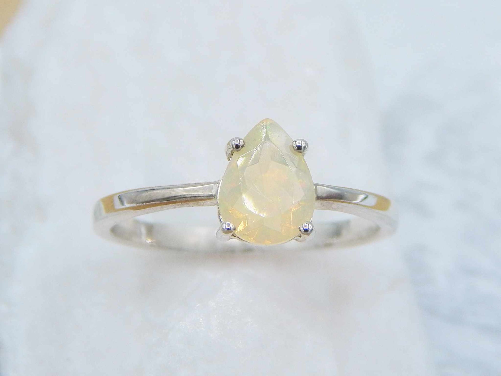 Opal Pear Cut Ring - Silver featuring a 10x8mm genuine opal gemstone in a 925 silver prong setting with a slim 2mm band.