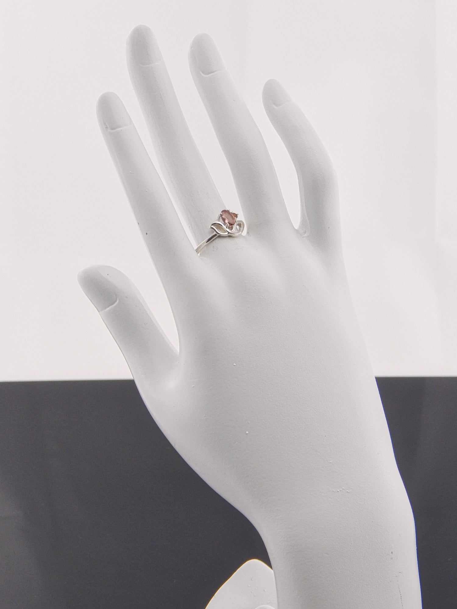 Genuine pink and orange tourmaline flower ring in 925 silver on mannequin hand.