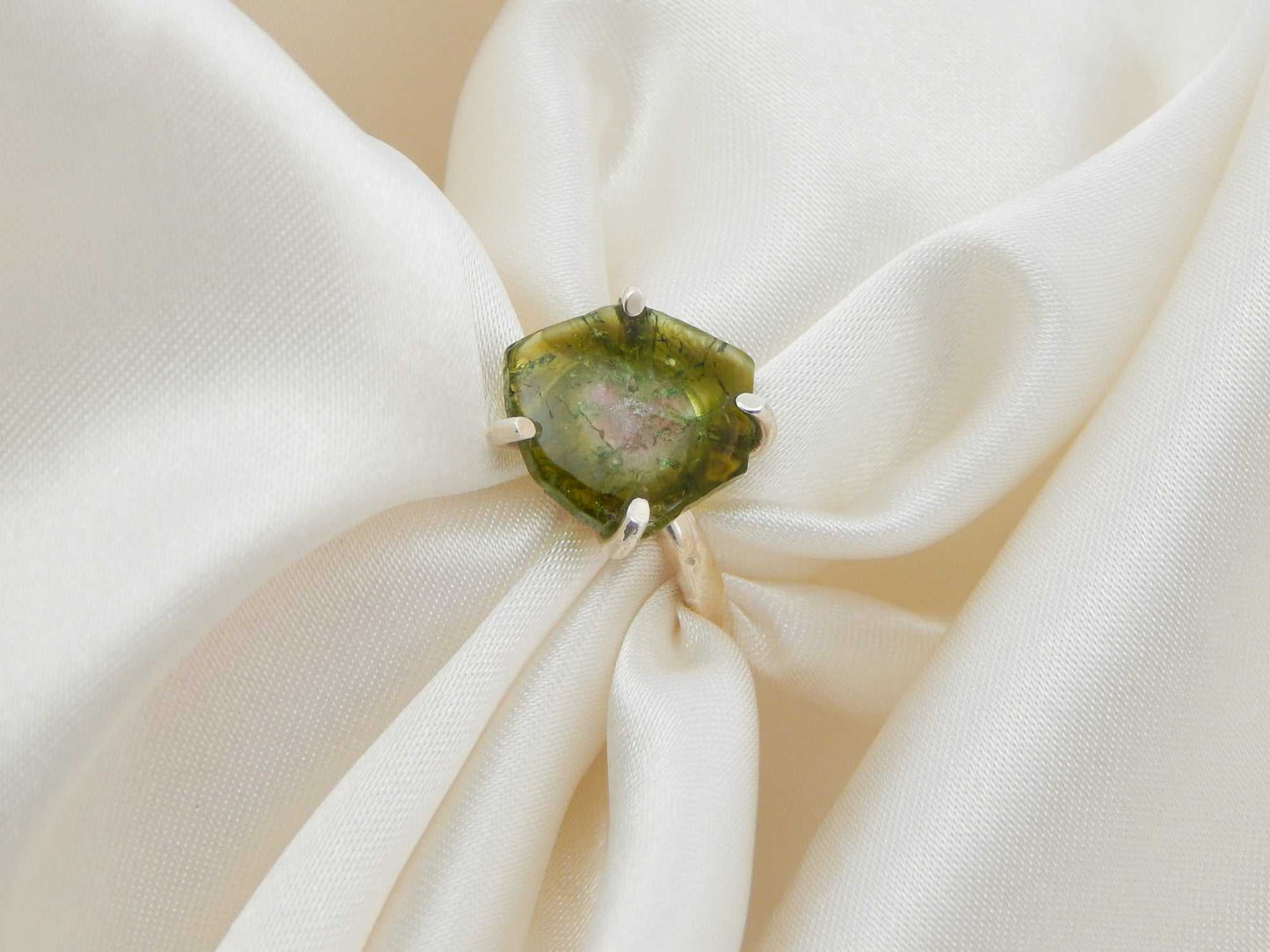 Genuine rough cut watermelon tourmaline ring in 925 sterling silver on satin fabric.