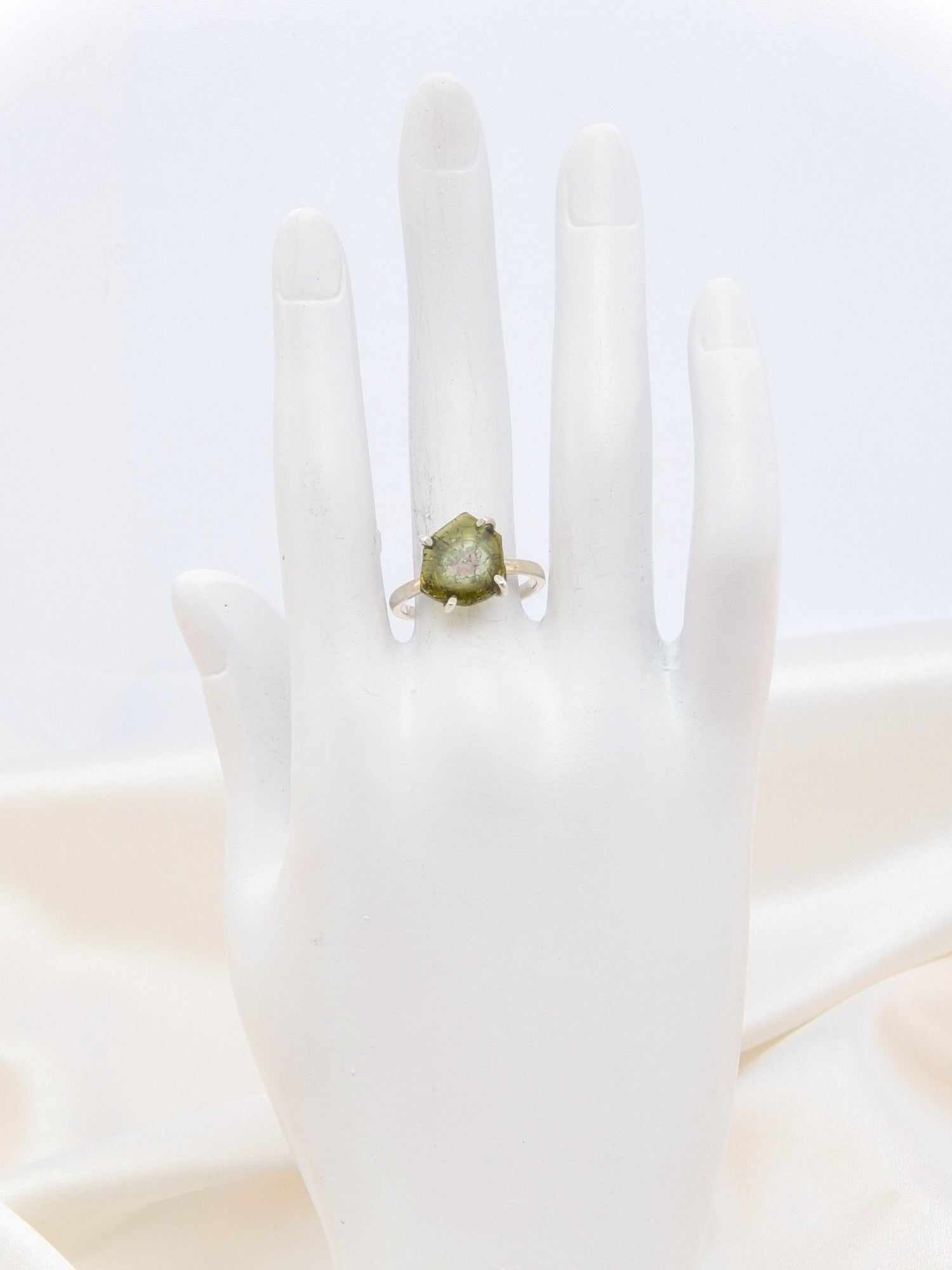 Genuine rough cut watermelon tourmaline ring in 925 sterling silver displayed on mannequin hand.