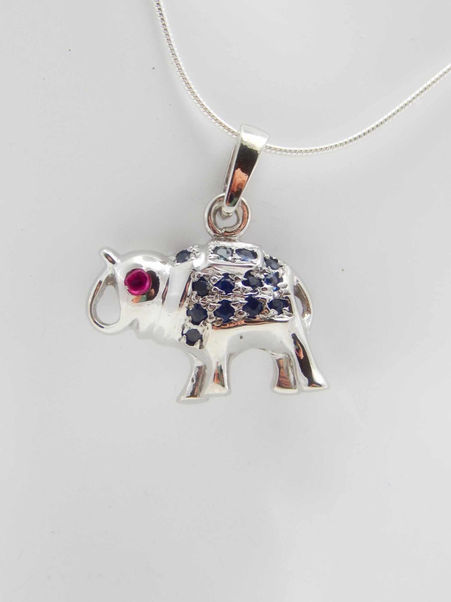 Genuine ruby and sapphire happy elephant necklace in 925 sterling silver.