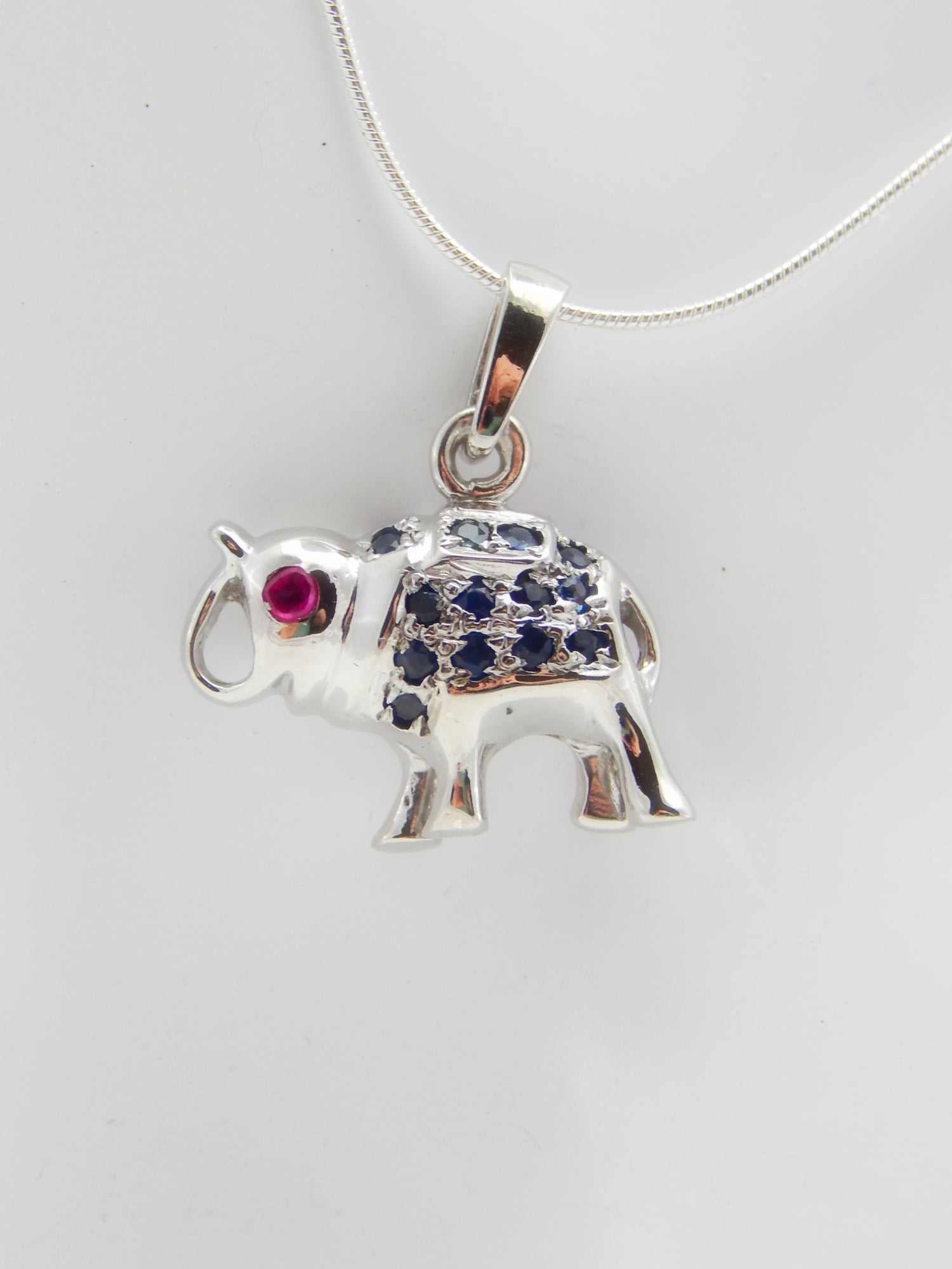 Genuine ruby and sapphire happy elephant necklace in 925 sterling silver.