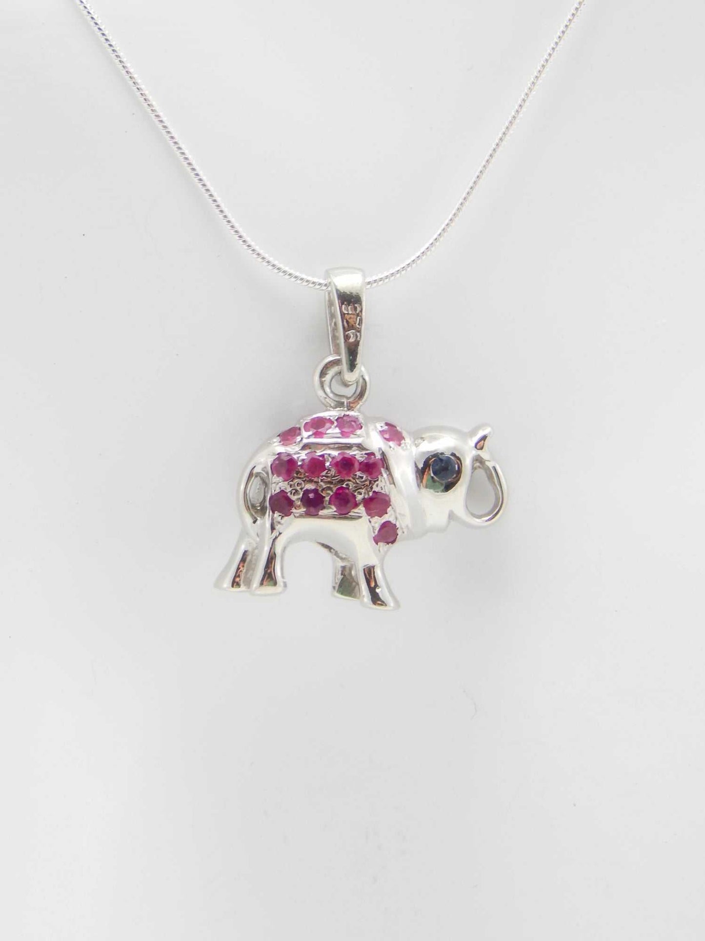 Genuine ruby and sapphire happy elephant necklace in sterling silver.