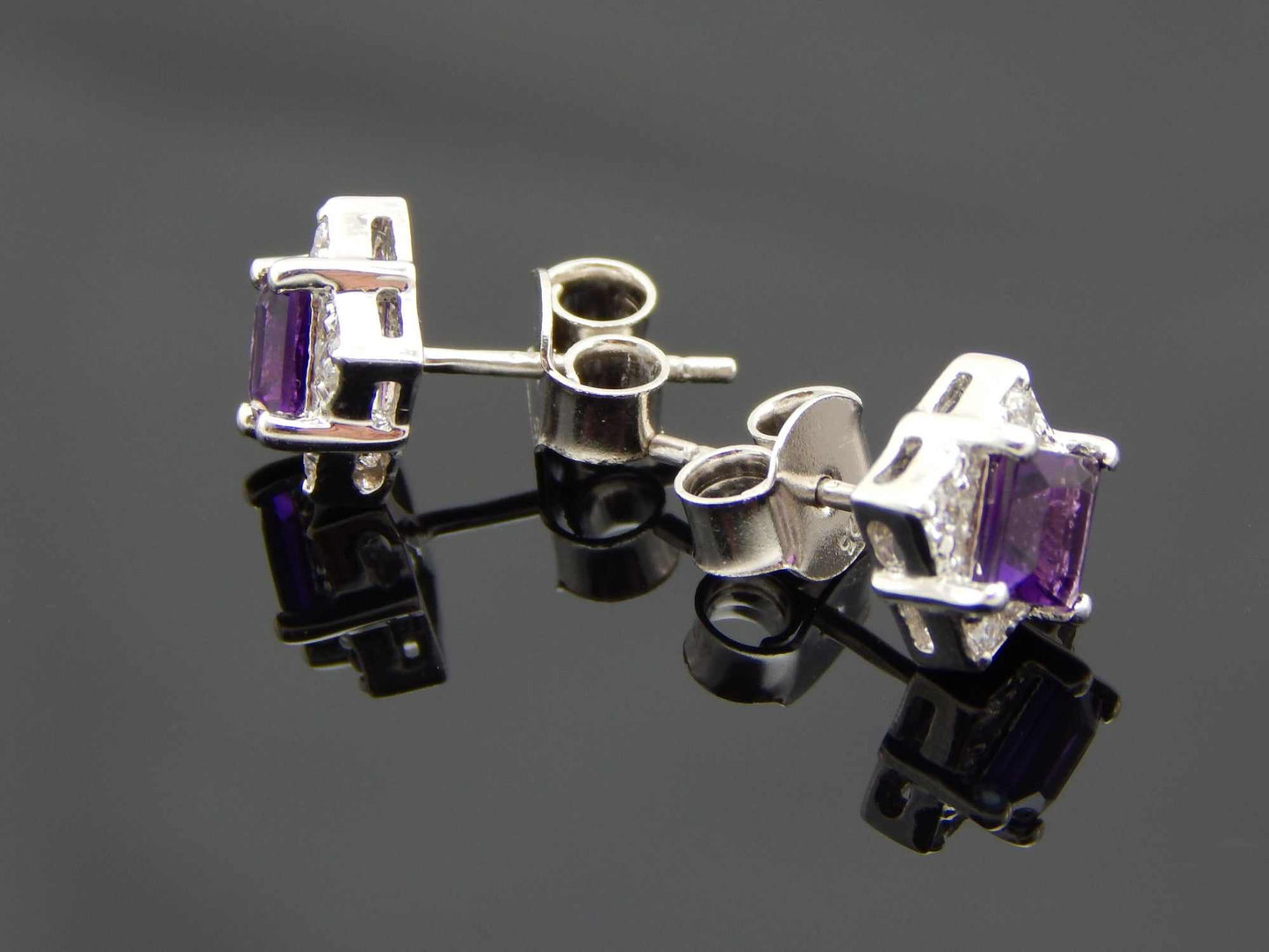 Cushion cut purple amethyst stud earrings in sterling silver.