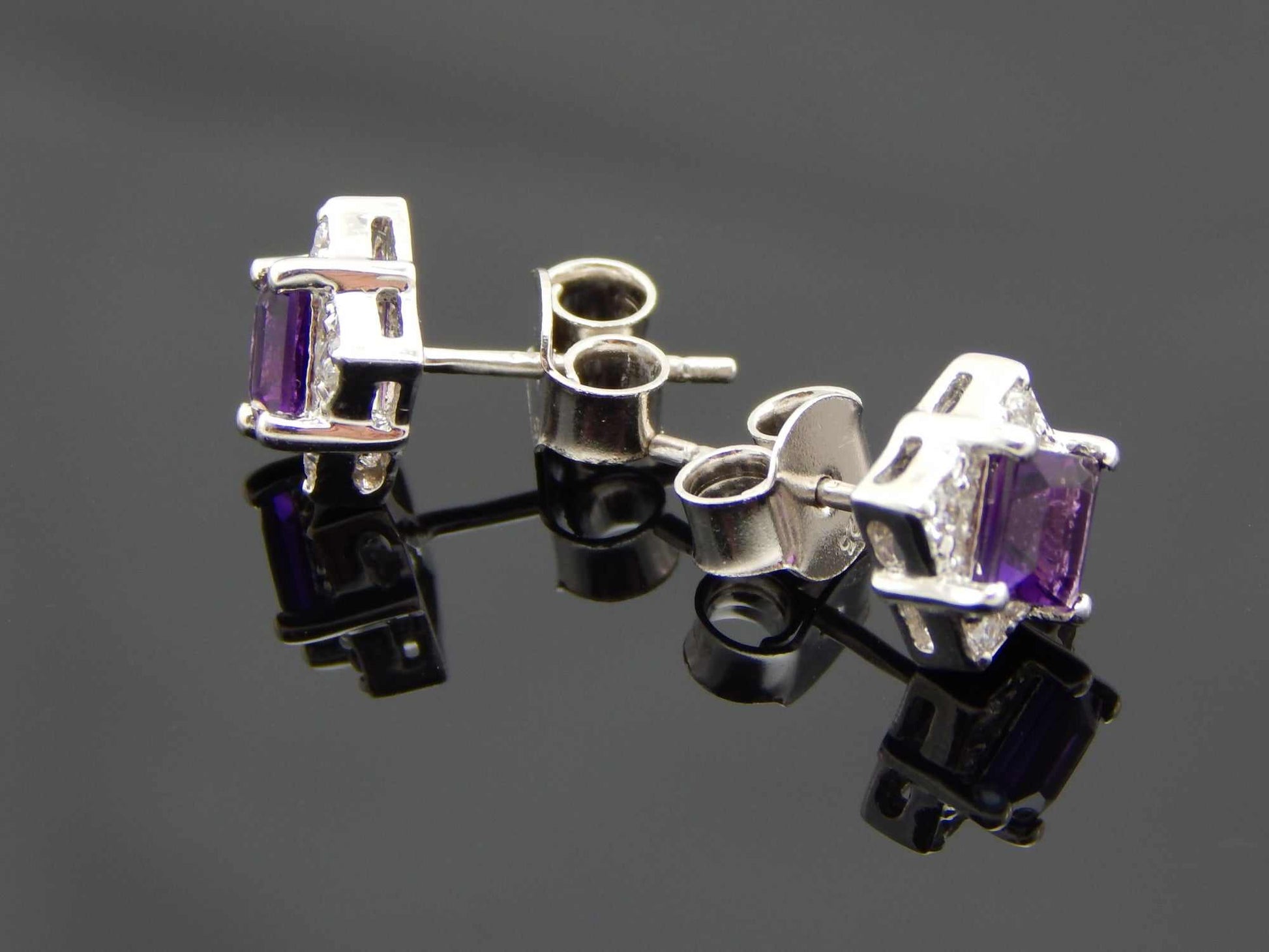 Cushion cut purple amethyst stud earrings in sterling silver.