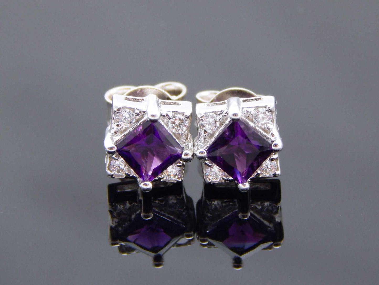 Cushion cut purple amethyst stud earrings in 925 sterling silver with cubic zirconia accents.