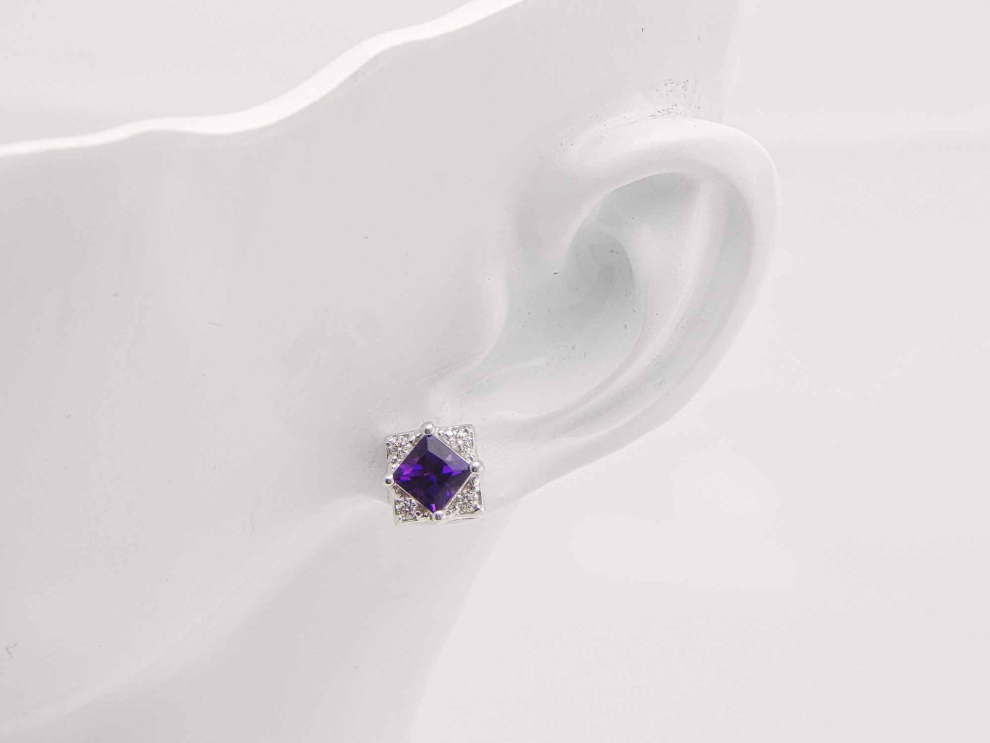 Cushion cut purple amethyst stud earring with cubic zirconia in sterling silver.